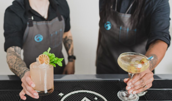 Bartenders serving cocktails